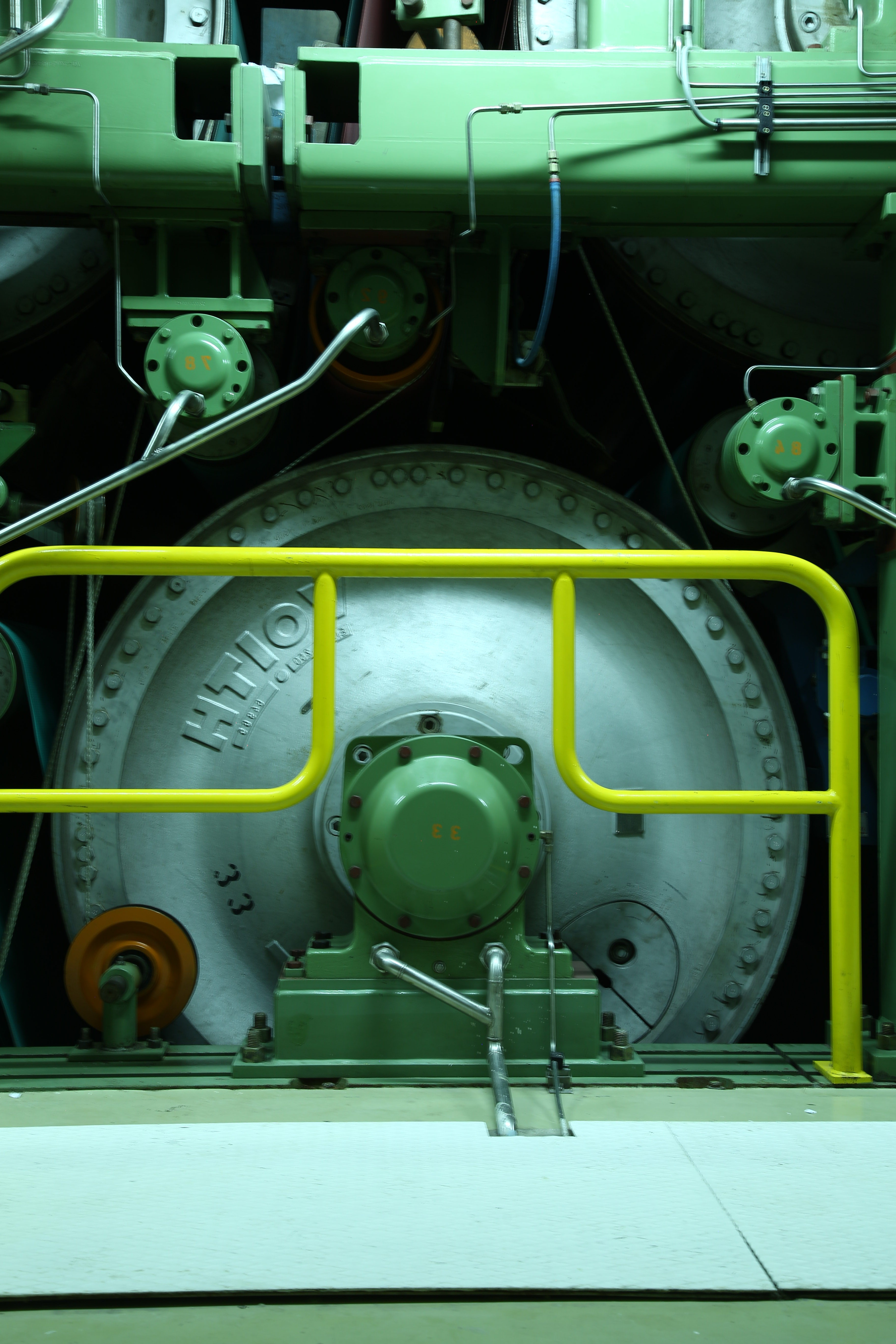 A close-up of paper mill roller machinery